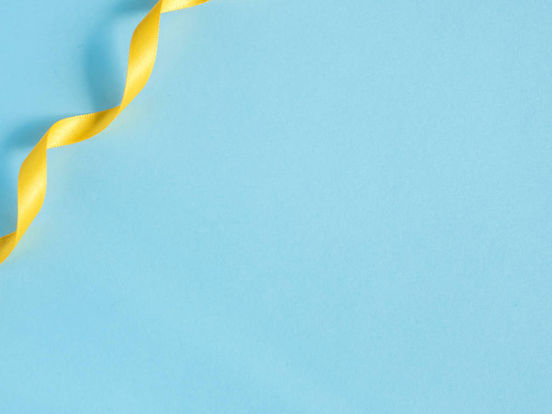 Holiday ribbon on blue background with copy space - Valokuva, kuva