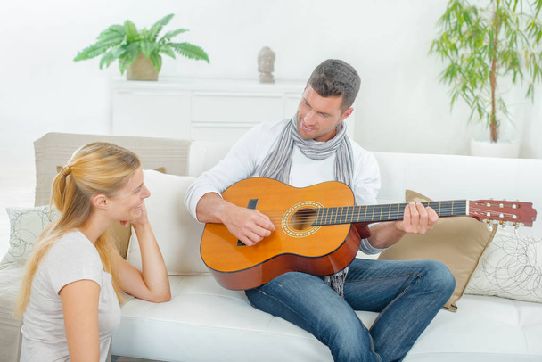 couple with guitar and aquaintance - 写真・画像
