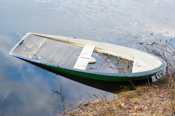 sunken rowing boat in a lake at Magdeburg in Germany - Photo, Image