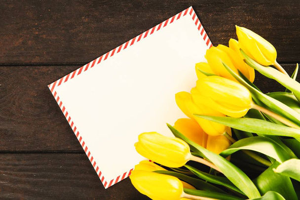 Yellow tulips on wooden background - Fotografie, Obrázek