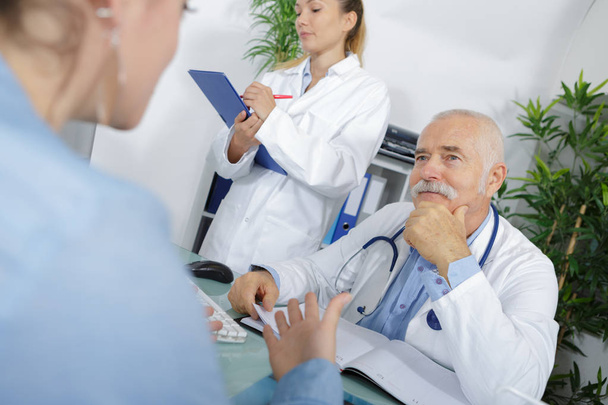 senior doctor discussing health concerns with a woman - Photo, image