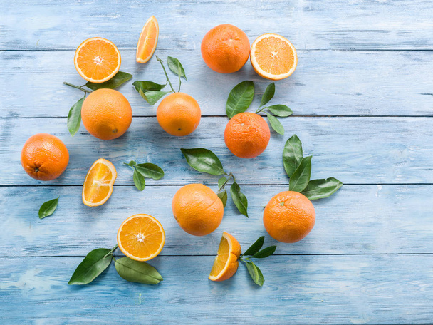 Ripe oranges on the blue wooden table. - Fotó, kép