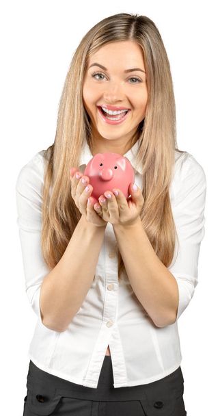 Mujer joven feliz con una caja de dinero aislada en blanco
 - Foto, imagen