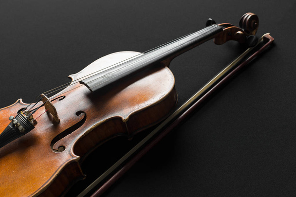 Old brown violin on black background - Fotó, kép