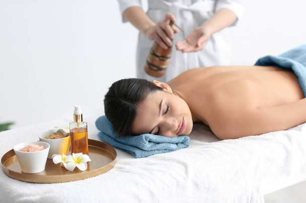 Young beautiful woman having massage in spa salon - Foto, afbeelding