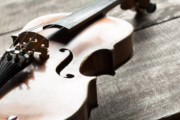 Violin on wooden table, close up view - 写真・画像