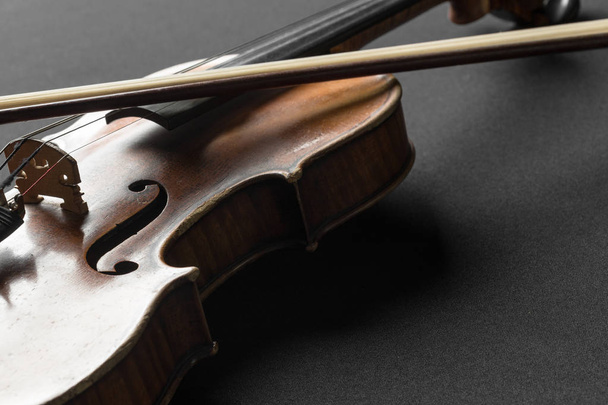 Old brown violin on black background - Foto, Imagen
