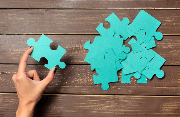 Hand holding puzzle pieces, business concept background - Photo, Image