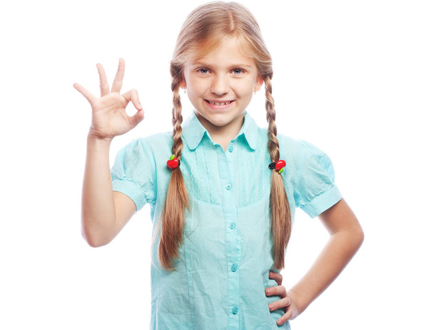 Close-up emotional portrait of attractive caucasian girl. Beautiful happy schoolgirl making ok gesture and looking at camera. - Photo, Image