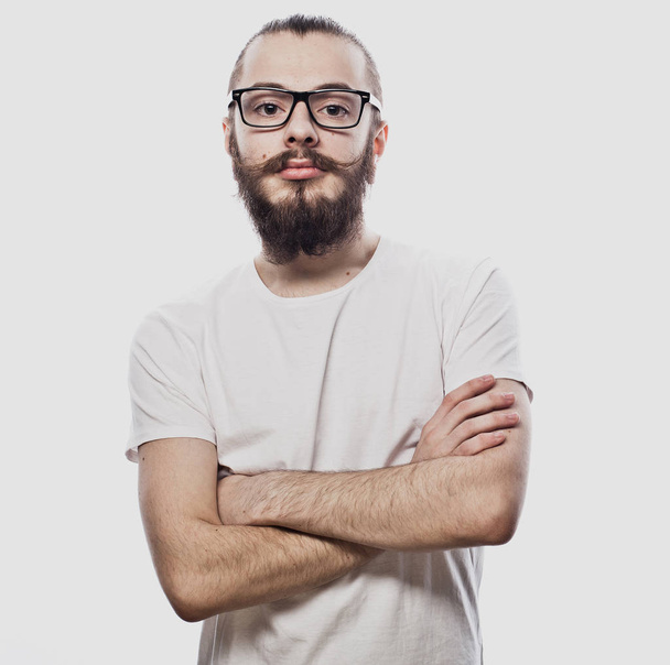 Lifestyle and people concept: Young bearded guy crossing his arms over white background - Фото, зображення