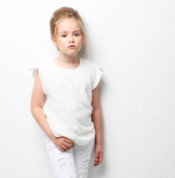 Beautiful Cute fashion girl in white clothes on white background. Childrens fashion. - Zdjęcie, obraz