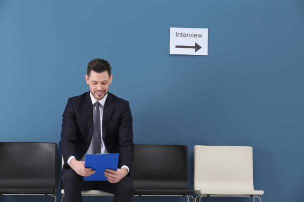 Young man waiting for job interview, indoors - Foto, Imagen