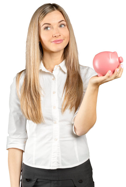 Happy young woman with a money box isolated on white - Фото, зображення