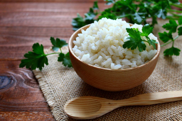 White rice in wooden bowl. Top view. - Photo, Image