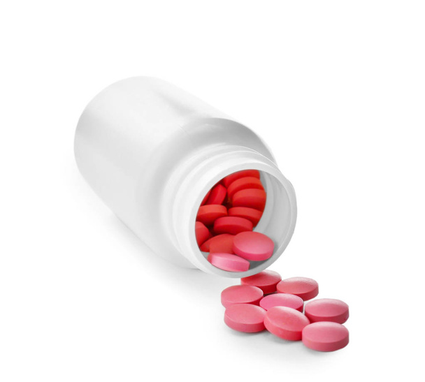 Container with pink pills on white background - Photo, image