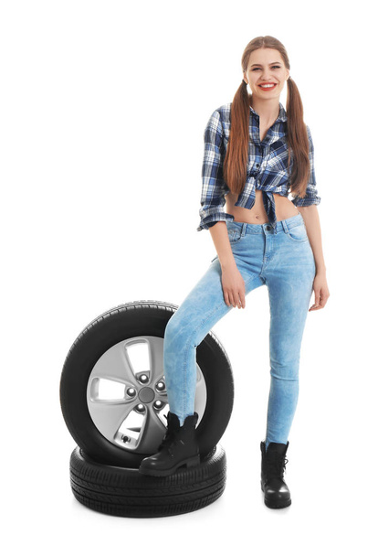 Young woman in seductive outfit with car tires on white background - Fotografie, Obrázek