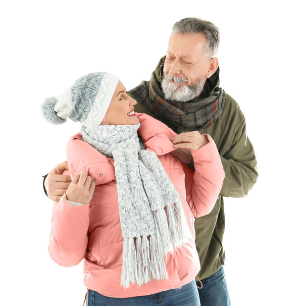 Mature couple in warm clothing on white background. Ready for winter vacation - Foto, Bild