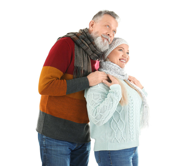 Mature couple in warm clothing on white background. Ready for winter vacation - Foto, imagen