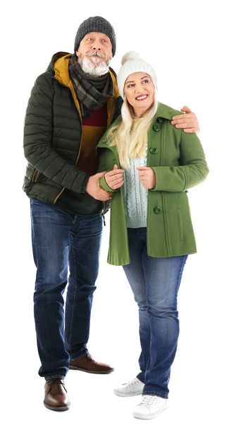 Mature couple in warm clothing on white background. Ready for winter vacation - Foto, Imagem