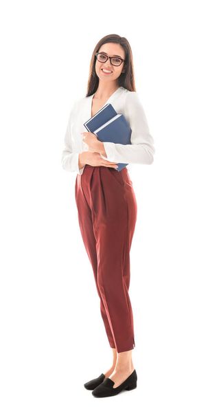 Female teacher with books on white background - Фото, изображение