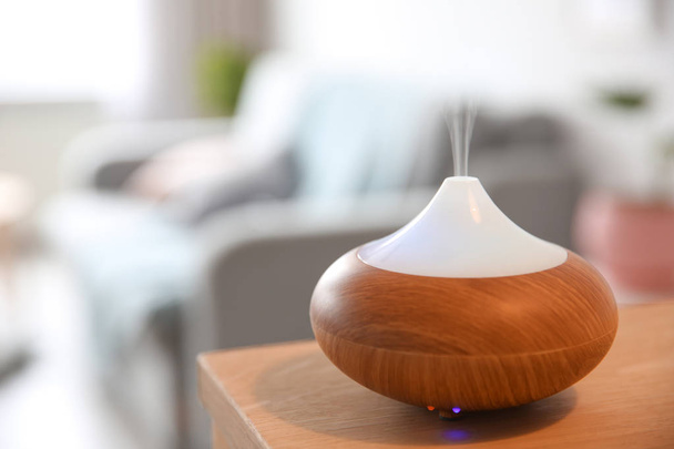 Aroma oil diffuser on table against blurred background - Zdjęcie, obraz