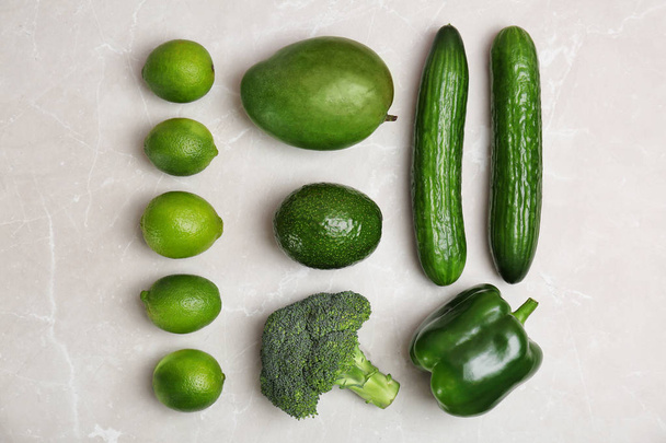 Different green vegetables and fruits on grey background, top view - Valokuva, kuva