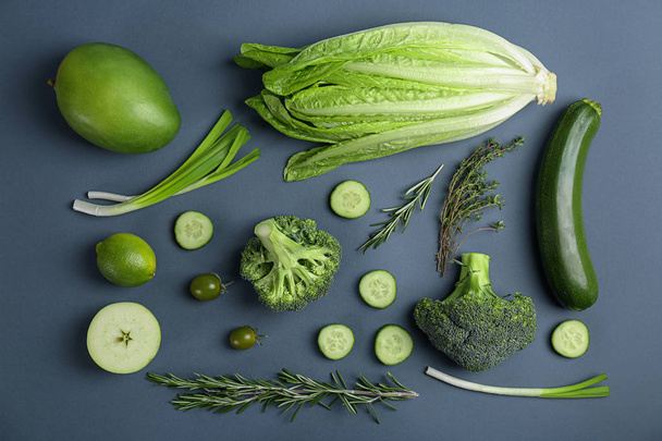 Different green vegetables and fruits on dark background, top view - Fotó, kép