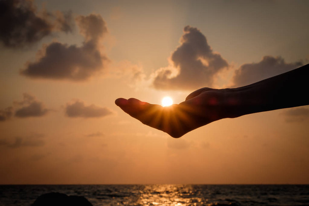 Силуэт Руки ловят падающее солнце
. - Фото, изображение