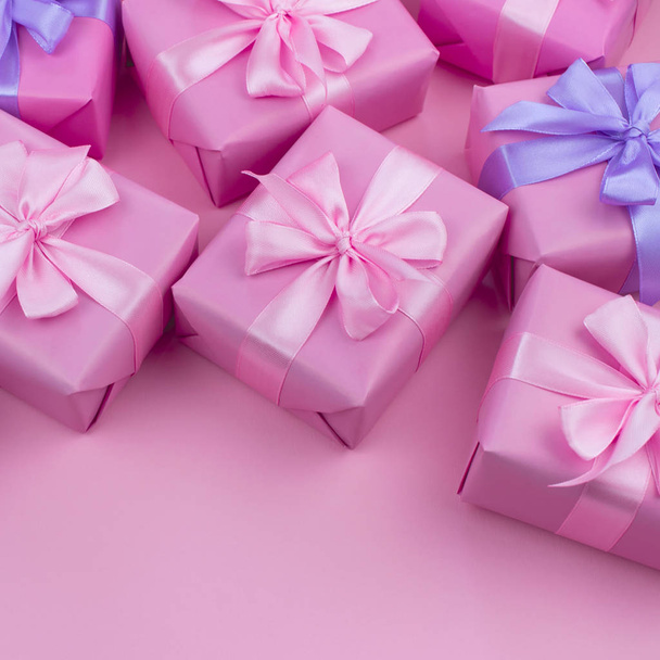 Decorative holiday gift boxes with pink color on pink background. Flat flat top view - Photo, Image