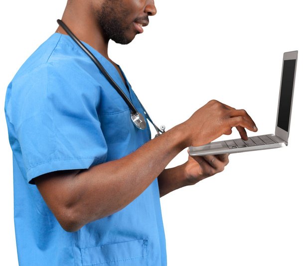 Friendly Afro-American doctor working on a laptop - Фото, изображение