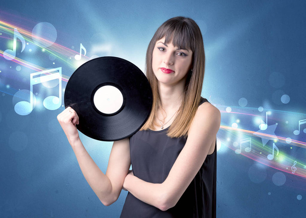 Lady holding vinyl record - Фото, изображение