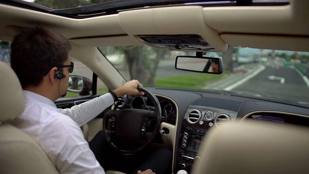 Successful businessman driving expensive car to work, transportation service - Foto, immagini