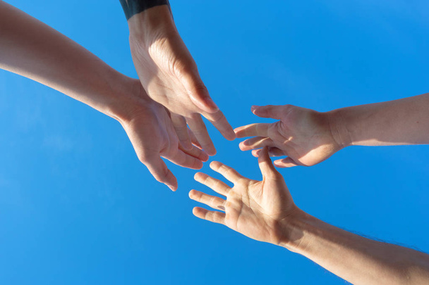 friends stacking hands on sky background - Φωτογραφία, εικόνα