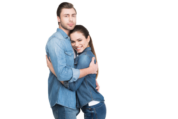 cheerful young couple embracing and looking at camera, isolated on white - Photo, Image