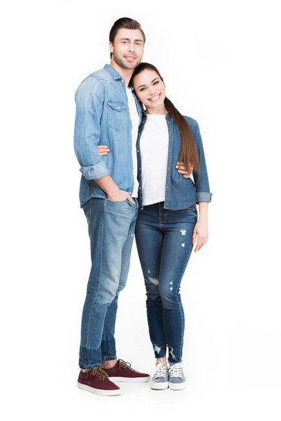 smiling young couple hugging and looking at camera, isolated on white - Photo, Image