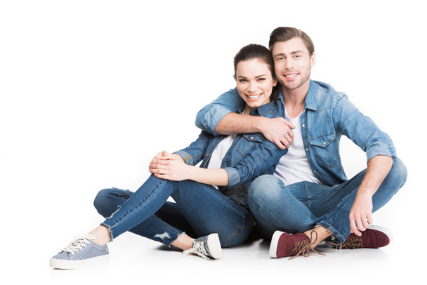 hugging couple sitting in denim clothes, isolated on white - Foto, immagini