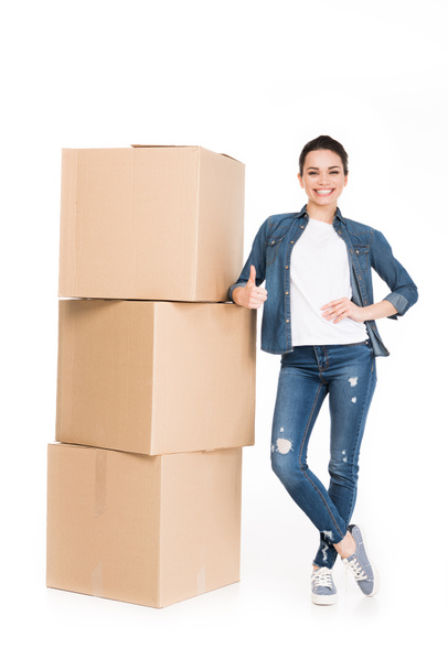 woman with cardboard boxes showing thumb up, isolated on white - Fotoğraf, Görsel