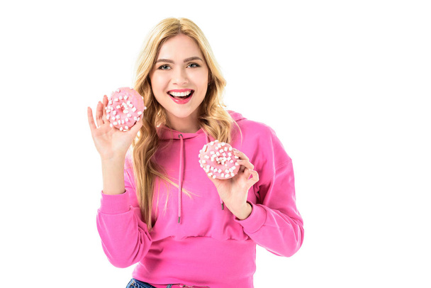 Young girl holding pink doughnuts isolated on white - Foto, afbeelding
