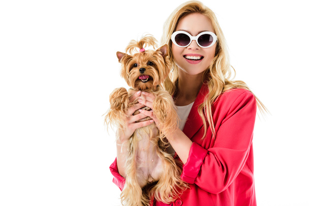 Blonde woman in pink clothes holding cute dog isolated on white - Zdjęcie, obraz