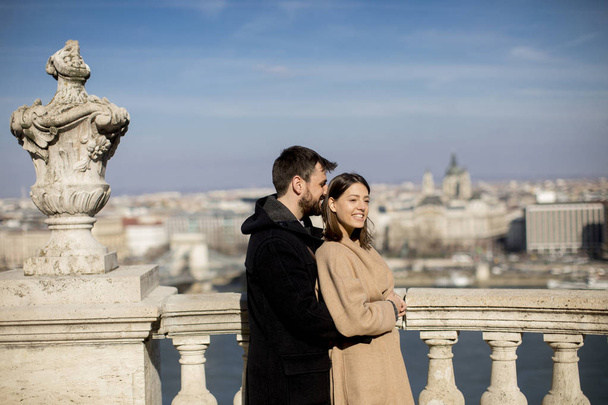 Young happy attractive couple in love hugging at the background of the magnificent landscape view of Budapest, Hungary - Photo, Image