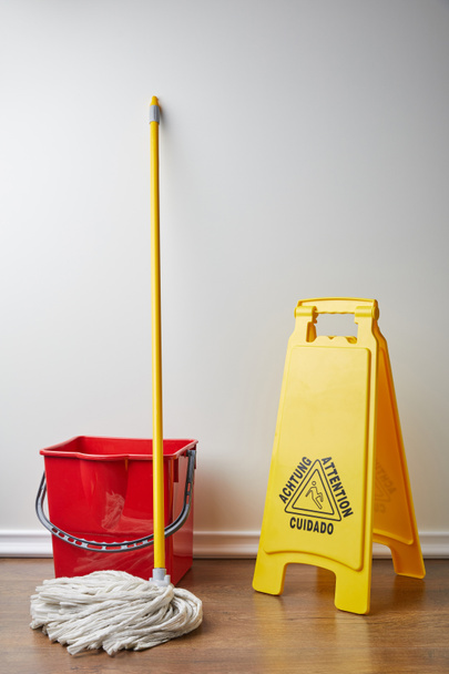 wet floor sign and bucket with mop for spring cleaning - Photo, Image
