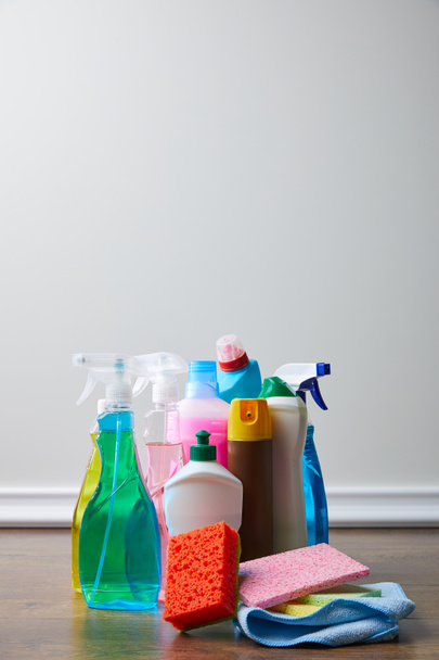 bottles with cleaners and spray bottles on floor for spring cleaning - Foto, immagini