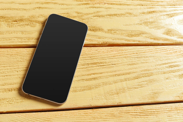Smartphone on wooden background. Top view. - Foto, Bild