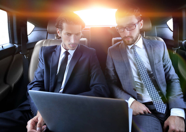 business partners sitting in a luxury car - Foto, Imagen