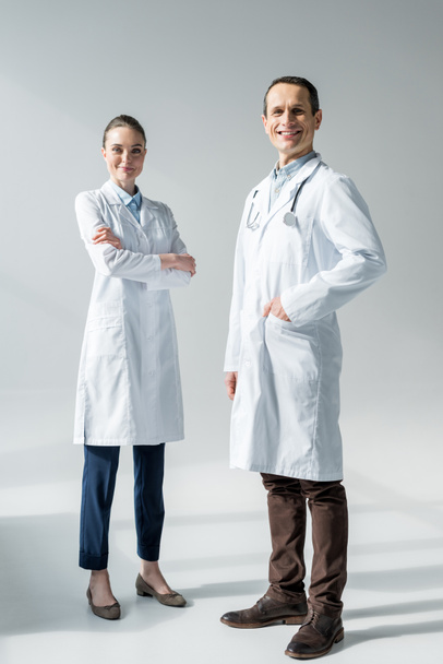 happy adult doctors looking at camera on white - Foto, immagini