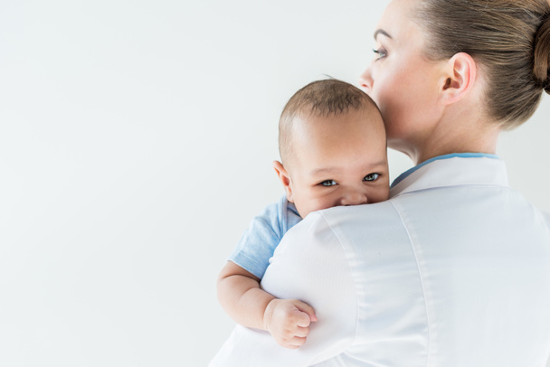 close-up shot of female pediatrician with african american baby isolated on white - Φωτογραφία, εικόνα