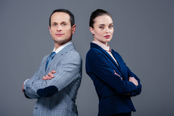 adult business colleagues standing back to back and looking at camera isolated on grey - Fotoğraf, Görsel