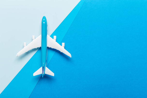 Miniature airplane on colourful background for travel theme - Φωτογραφία, εικόνα