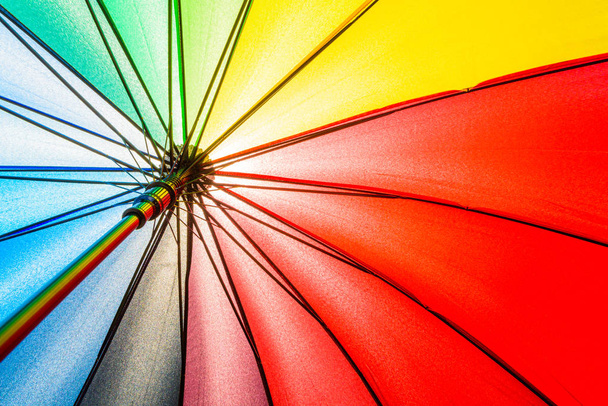 Bottom view of Rainbow umbrella texture background. - Photo, Image
