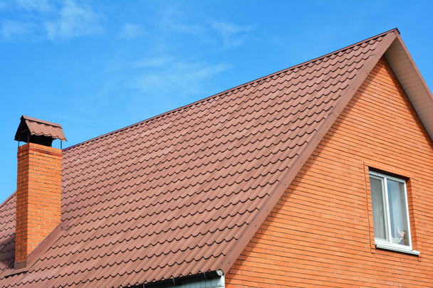 Close up on brick house metal  roof with chimney. - Valokuva, kuva